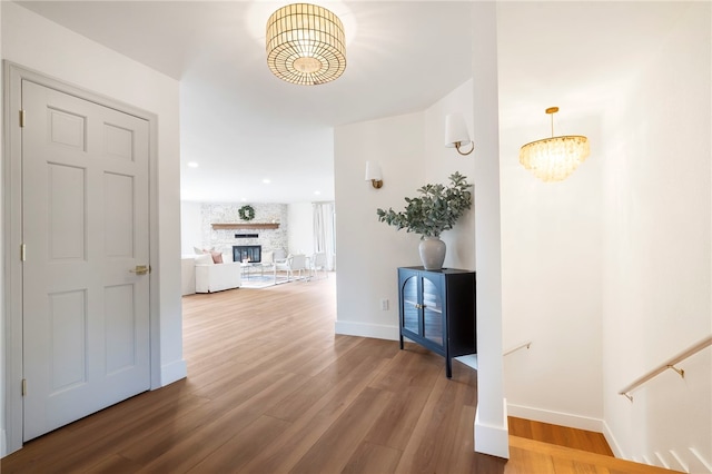 hall featuring hardwood / wood-style floors and a chandelier