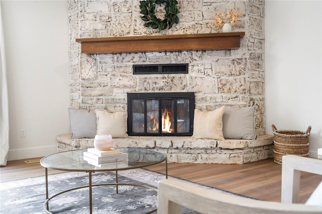 room details featuring a fireplace and hardwood / wood-style floors