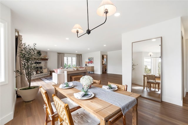 dining space with hardwood / wood-style floors and a healthy amount of sunlight