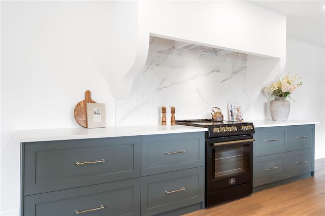 kitchen featuring tasteful backsplash, light wood-type flooring, and black electric range