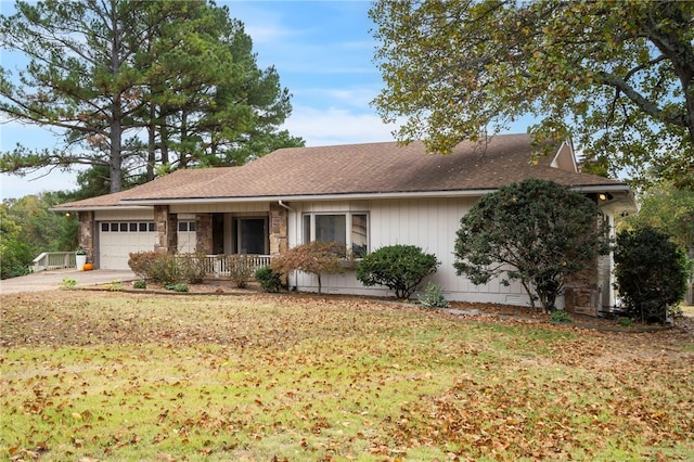 ranch-style home with a porch, a garage, and a front yard