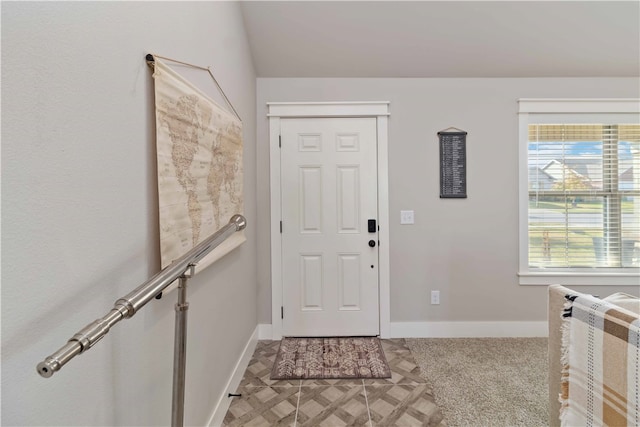 view of carpeted foyer entrance