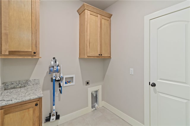 clothes washing area featuring cabinets, electric dryer hookup, hookup for a washing machine, and light tile patterned floors