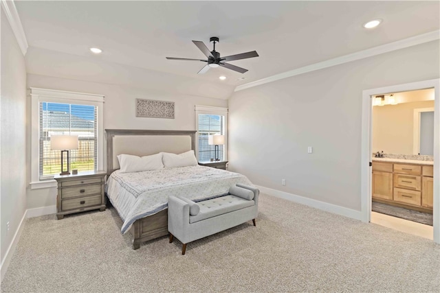 carpeted bedroom featuring crown molding, ceiling fan, ensuite bathroom, and vaulted ceiling