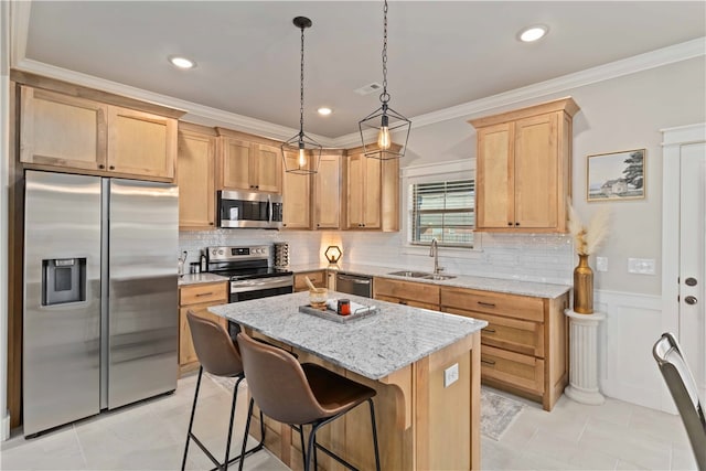 kitchen featuring sink, light stone counters, a center island, ornamental molding, and appliances with stainless steel finishes