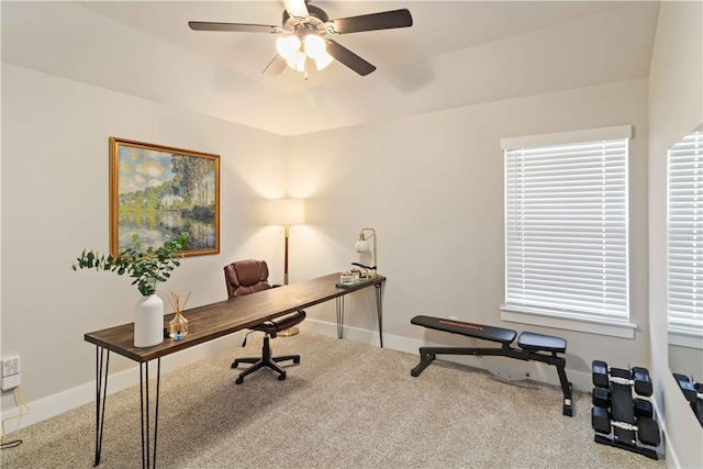 office area with a healthy amount of sunlight, carpet flooring, and ceiling fan