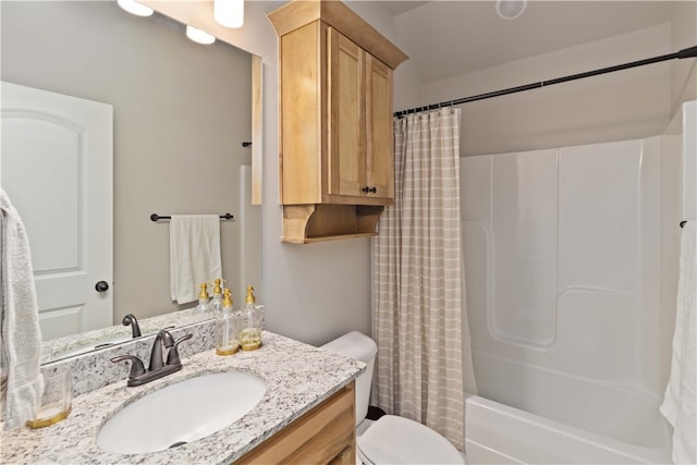 full bathroom featuring vanity, shower / bath combo with shower curtain, and toilet