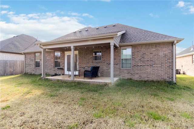 back of house featuring a patio and a yard