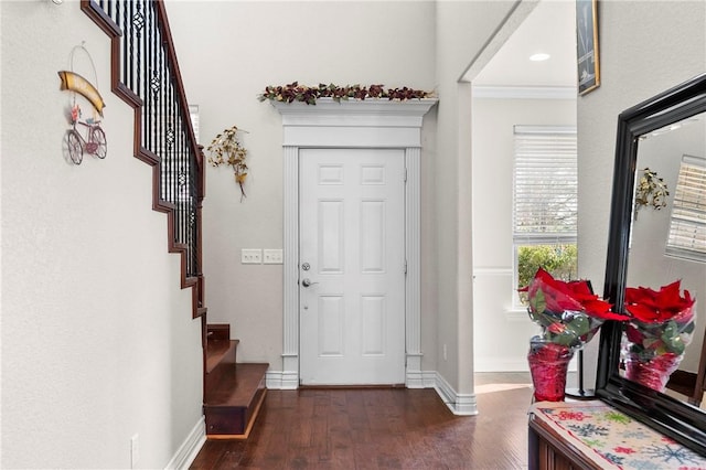 entrance foyer featuring dark hardwood / wood-style flooring and crown molding