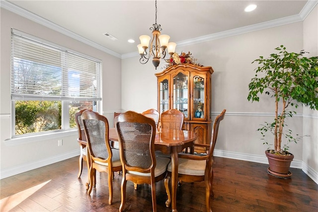 dining space with dark hardwood / wood-style flooring, crown molding, a wealth of natural light, and a chandelier