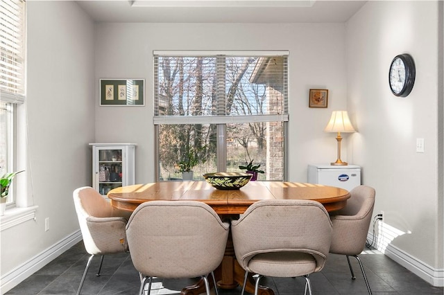 dining area with dark tile patterned flooring