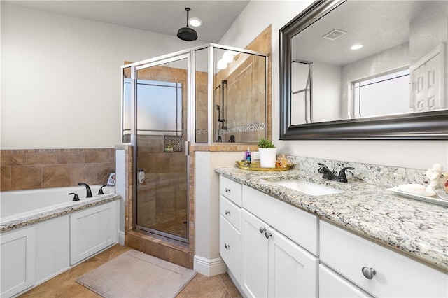 bathroom featuring tile patterned floors, vanity, and plus walk in shower