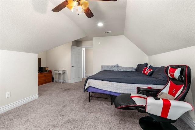 carpeted bedroom featuring a textured ceiling, ceiling fan, and lofted ceiling