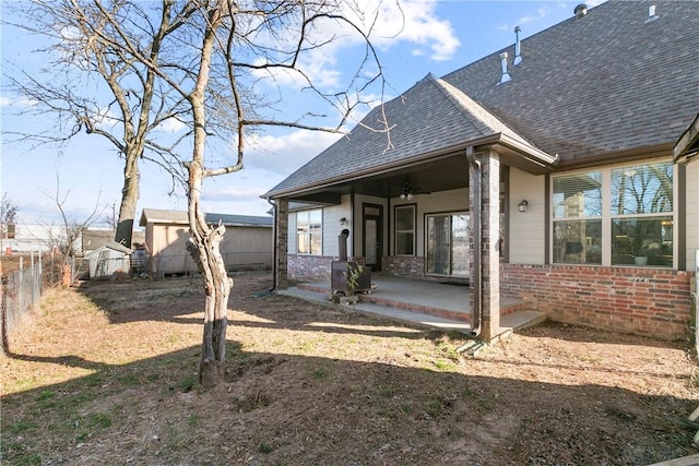 back of property featuring ceiling fan and a patio area