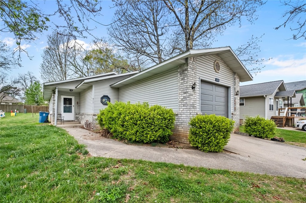 view of front of property featuring a front lawn, a garage, and a deck