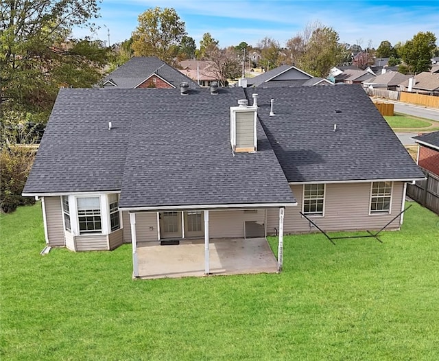 rear view of property with a yard and a patio