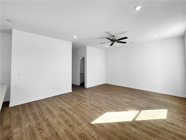 unfurnished living room featuring recessed lighting, wood finished floors, baseboards, and ceiling fan