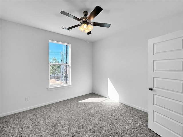 spare room featuring visible vents, baseboards, a ceiling fan, and carpet flooring