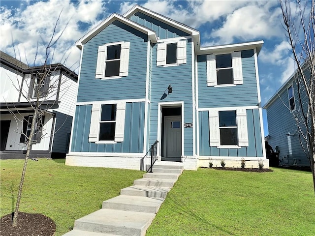 view of front of home with board and batten siding and a front yard