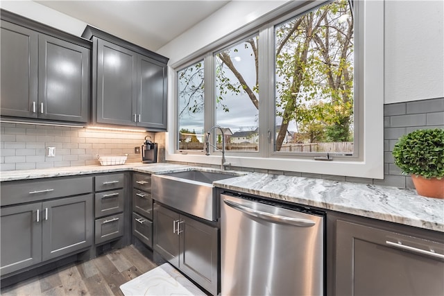 kitchen with dishwasher, plenty of natural light, dark wood-type flooring, and sink