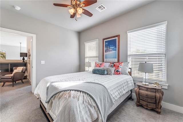 bedroom with carpet, ceiling fan, and multiple windows