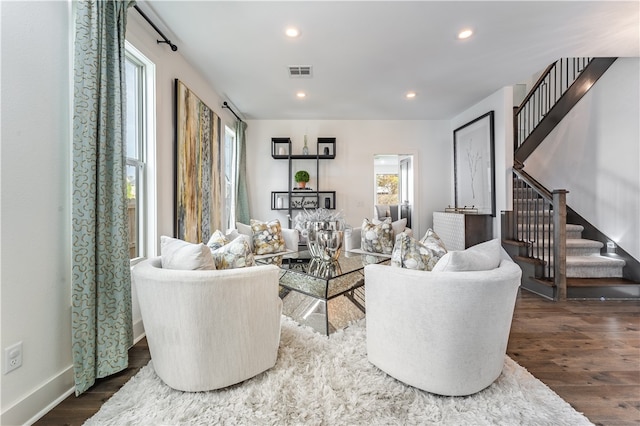 living room with a healthy amount of sunlight and dark hardwood / wood-style flooring