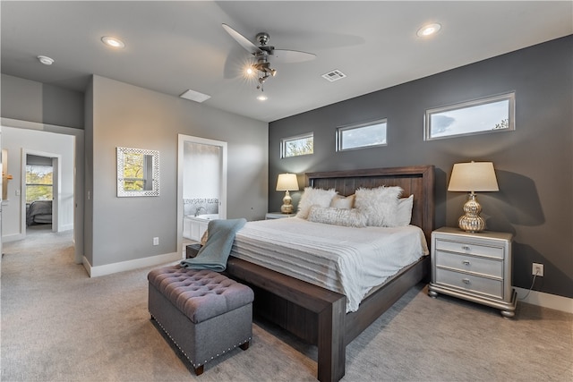 bedroom featuring carpet, ensuite bath, and ceiling fan