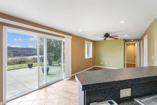 interior space featuring tile patterned floors and ceiling fan