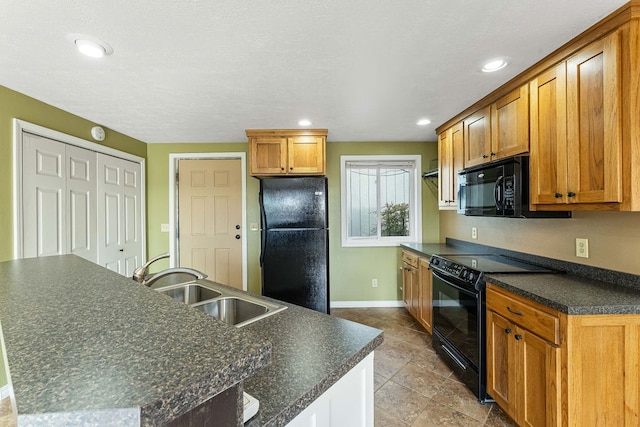 kitchen featuring sink, a center island, and black appliances