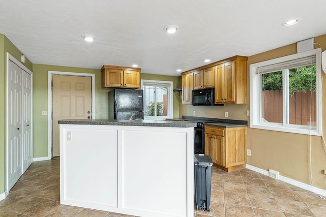 kitchen with tasteful backsplash, a kitchen island, and black appliances