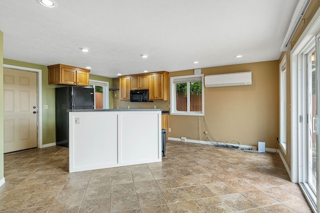 kitchen featuring an AC wall unit, dark stone countertops, and black appliances