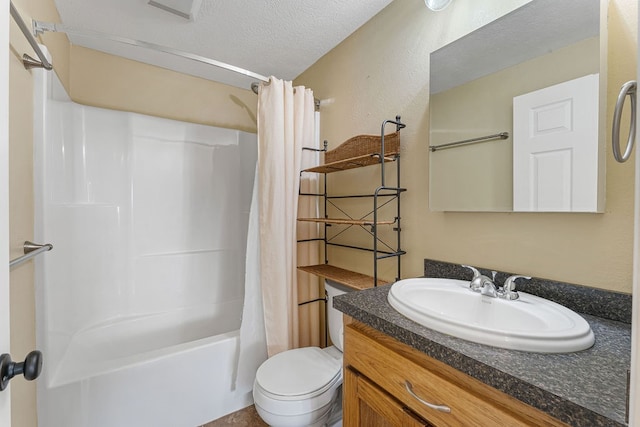 full bathroom with shower / bath combo with shower curtain, vanity, a textured ceiling, and toilet