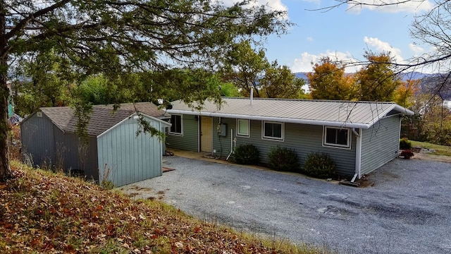 ranch-style house featuring a storage shed