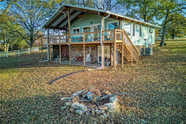 rear view of property featuring central AC unit, a patio area, ceiling fan, and a deck