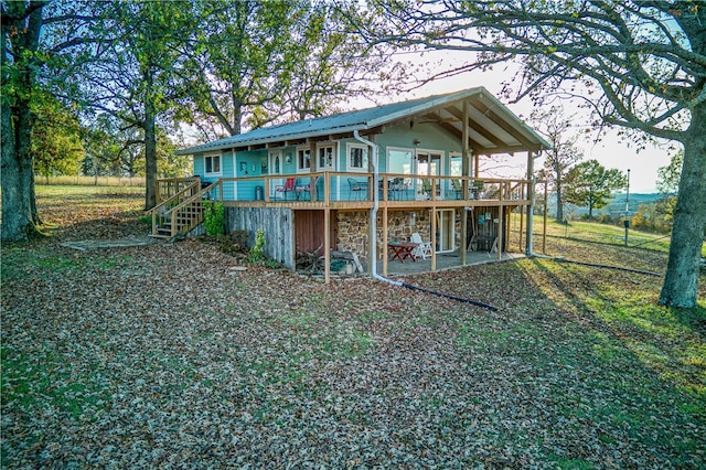 rear view of property with a wooden deck