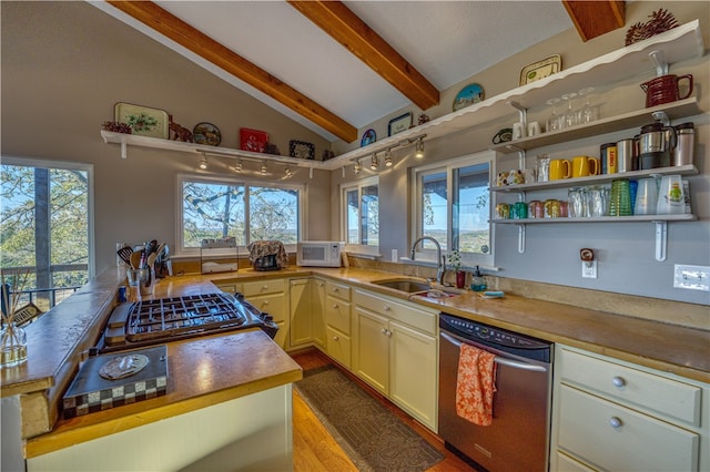 kitchen with light hardwood / wood-style floors, sink, appliances with stainless steel finishes, butcher block countertops, and lofted ceiling with beams