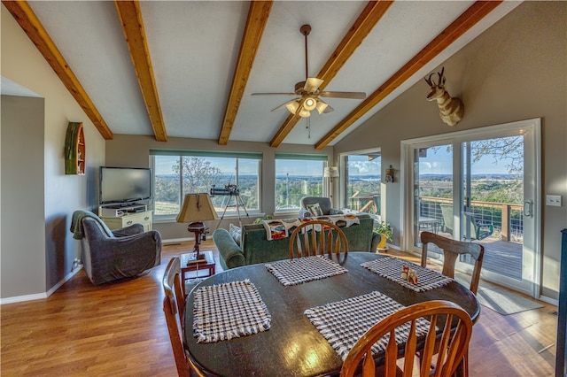 dining area with ceiling fan, light hardwood / wood-style floors, and vaulted ceiling with beams