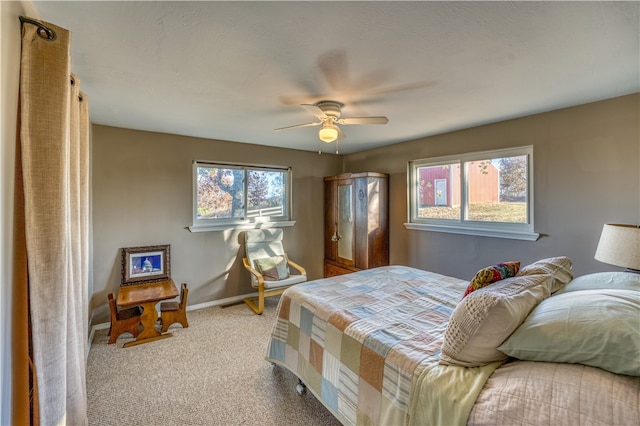 carpeted bedroom featuring multiple windows and ceiling fan