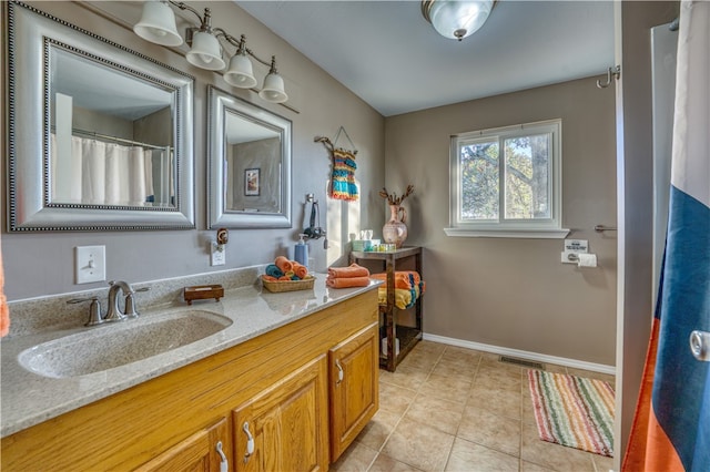 bathroom featuring tile patterned flooring and vanity