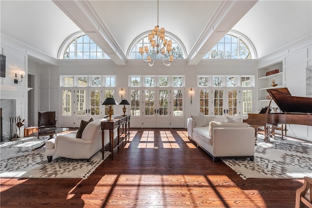 living room featuring dark wood-type flooring, a high ceiling, and built in shelves