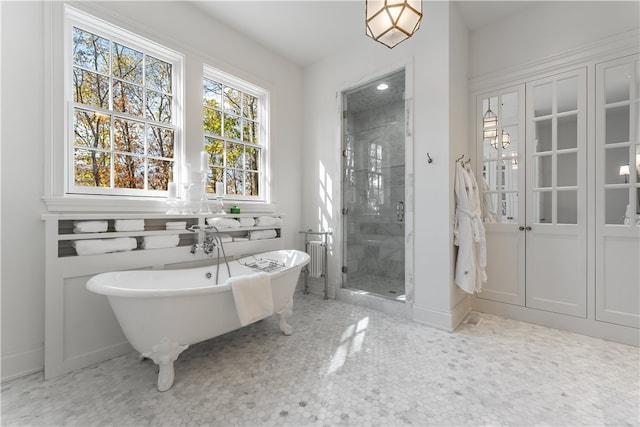 bathroom featuring separate shower and tub