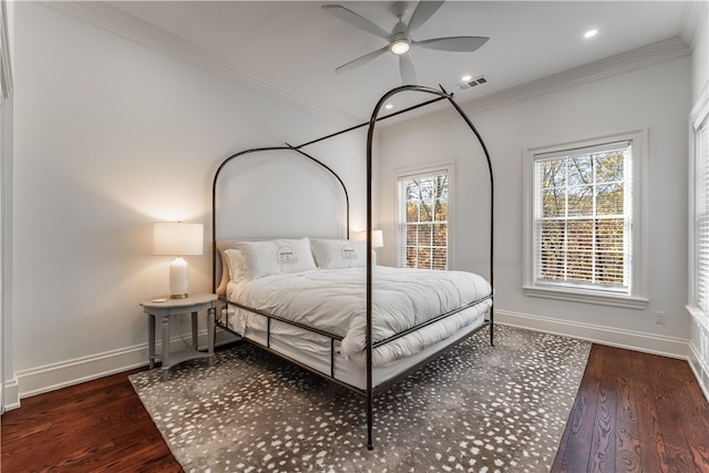 bedroom with dark hardwood / wood-style flooring, ornamental molding, and ceiling fan