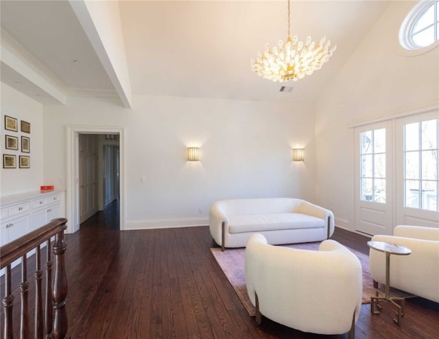 living room with dark wood-type flooring, high vaulted ceiling, and a notable chandelier