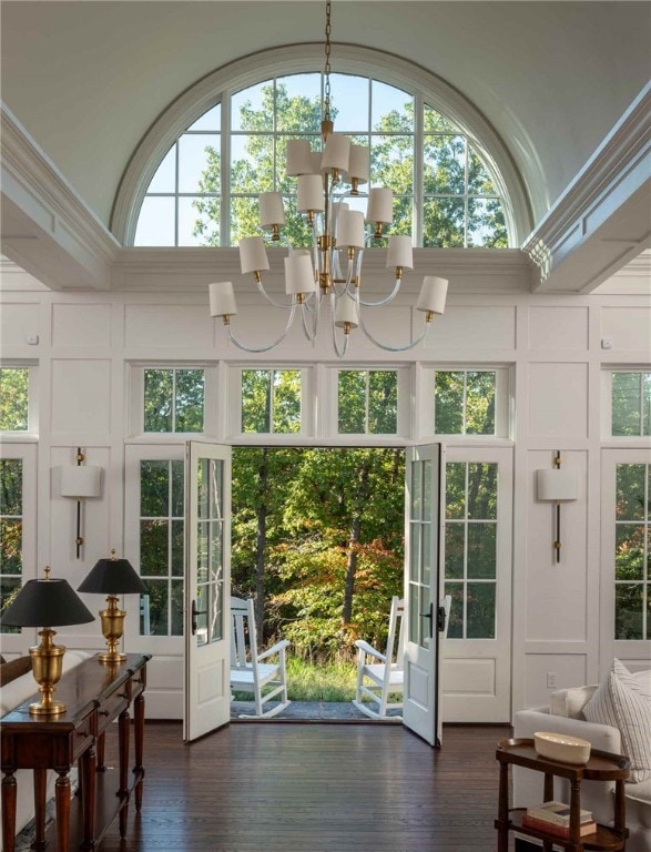 doorway to outside with a chandelier, french doors, a healthy amount of sunlight, and dark hardwood / wood-style floors