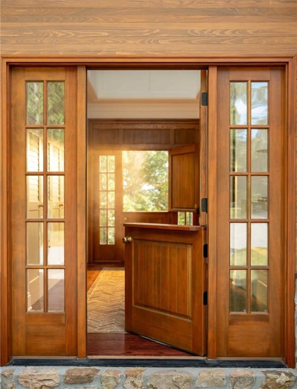 entryway with a wealth of natural light, french doors, and hardwood / wood-style flooring