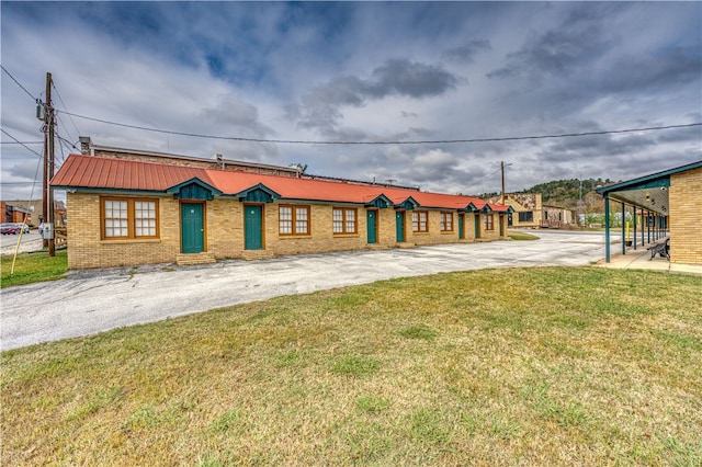 ranch-style home with a carport and a front yard