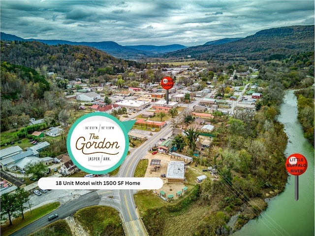 birds eye view of property with a water and mountain view