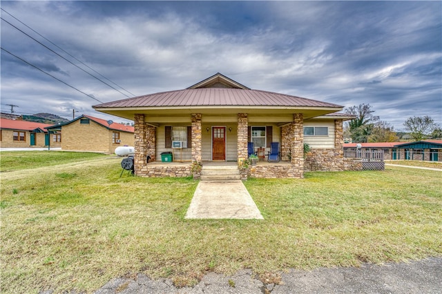 view of front of house featuring a front lawn and covered porch