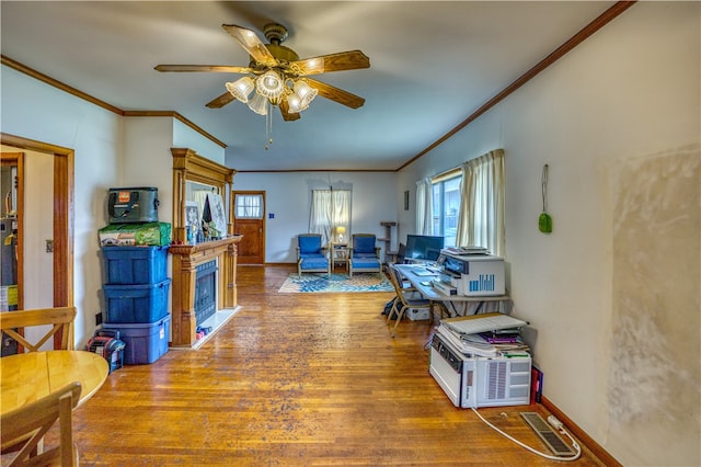 home office featuring wood-type flooring, ceiling fan, and crown molding