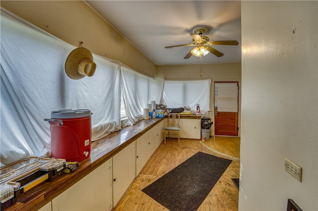 kitchen featuring white cabinets, light hardwood / wood-style floors, wood counters, and ceiling fan